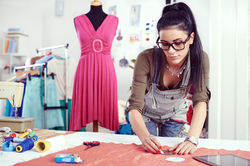 Woman Measuring Material in Studio